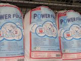 three bags of powerflo on display in a store