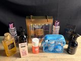 a wooden table topped with bottles of perfume and other items