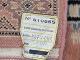 a close up of a rug with a tag on it