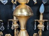 a gold colored chandelier with crystal beads hanging from it