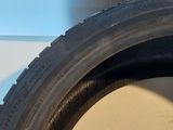a close up of a tire on a white surface