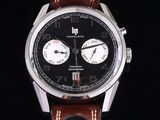 a close up of a watch with a black face and brown leather strap