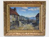 an oil painting of a village scene in a gold frame on a white wall