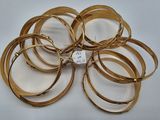 a lot of gold bracelets on a white surface