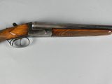 an old gun with a wooden handle on a white surface