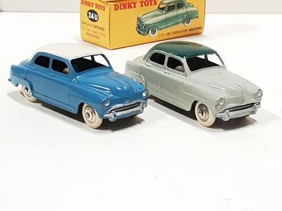 two toy cars sitting next to each other on a table