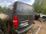 a van that is parked in a lot next to a fence