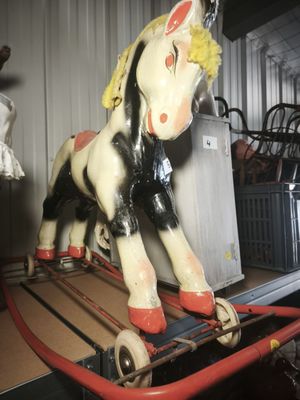 a toy horse that is sitting on top of a cart