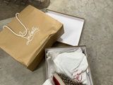 a box with a pair of shoes in it on the floor