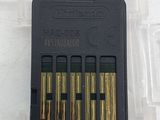 a plastic case with four gold bullet cartridges in it