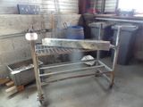 a metal work bench in the middle of a room