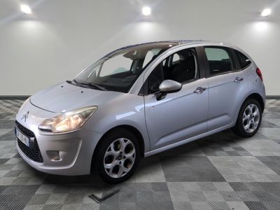 la petite voiture argentée est garée sur un carrelage à carreaux