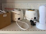 a white blender sitting on a shelf next to other appliances