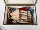 an open suitcase filled with clothes and a teddy bear