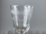 a glass with a pattern on it sitting on a table