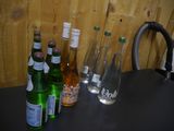 many bottles of water and bottles of wine sitting on a table