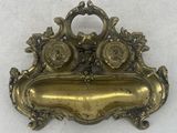 an antique brass plate with a flower design on it