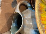 a vase and a pitcher sitting on a table