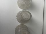 three empty water bottles on a white refrigerator door