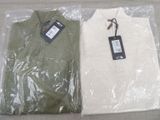 two men ' s shirts wrapped in plastic on the floor