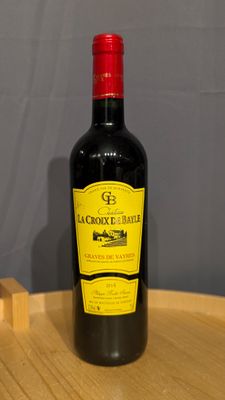 a bottle of wine sitting on a wooden tray