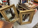 three picture frames sitting on the floor next to each other