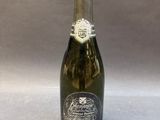 an old bottle of champagne sitting on top of a table