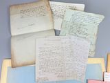 several old letters and papers are stacked on top of each other