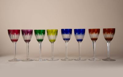 six different colored wine glasses lined up in a row