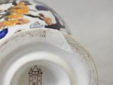 a close up of a vase with a castle on it