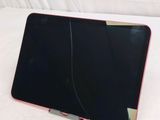 a laptop computer sitting on top of a white sheet