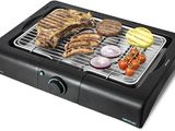 an image of a grill with meat and vegetables on it
