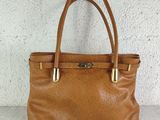 an image of a brown leather handbag on a white surface