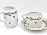 a cup and saucer sitting next to each other on a table