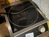 a black and silver stove top with a black burner on it