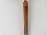 a close up of a wooden hammer on a white surface