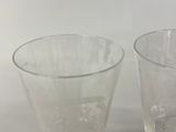two glasses sitting next to each other on a table