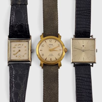 three different types of watches are displayed on a white surface
