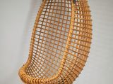 an image of a wicker hanging chair on a white wall