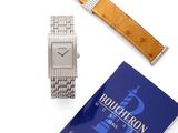 an image of a watch and a book on a white surface