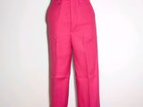 pink pants on a mannequin stand against a white wall