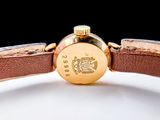 a close up of a watch on a white surface