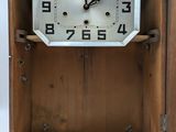 a wooden box with a clock inside of it