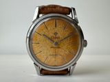 a close up of a watch on a white surface
