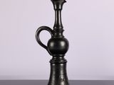 a black vase that is sitting on a table