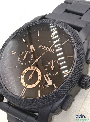 gros plan d'une montre noire sur une surface blanche