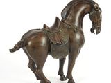 bronze statue of a horse with a saddle on it ' s back