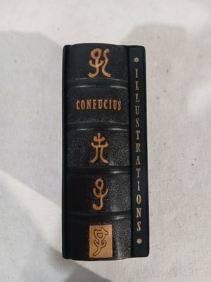 a black book with chinese writing on it sitting on a table