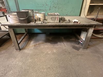 une table sur laquelle se trouve un seau, au milieu d'une pièce