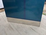 a blue couch that is sitting on the ground
